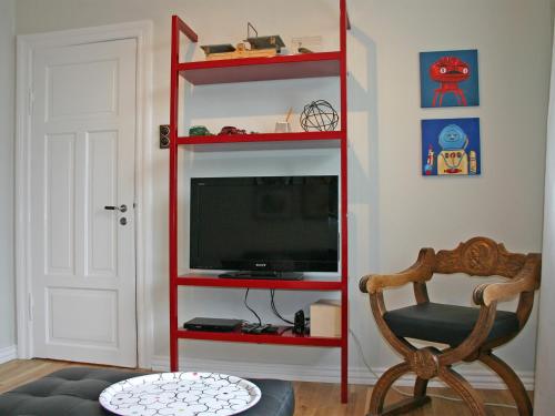 a red shelf with a television in a room at Nest Apartments in Reykjavík