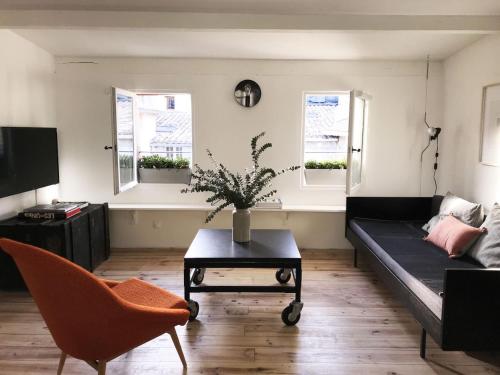 - un salon avec un canapé, une table et 2 fenêtres dans l'établissement La Magnanerie, à LʼIsle-sur-la-Sorgue