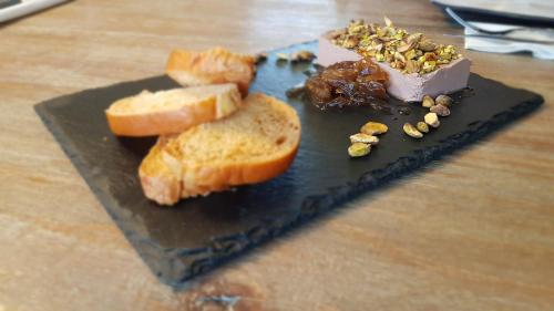 a black plate with bread and toast on a table at צימר גראפה בערבה - Grappa in Yahel