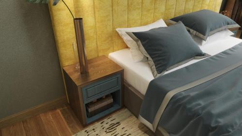 a bedroom with a bed and a nightstand next to a bed sidx sidx sidx at Centric Baku Boutique Hotel in Baku