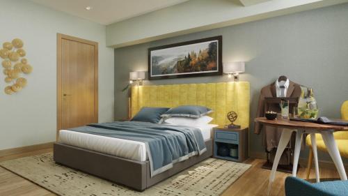 a bedroom with a bed with a yellow headboard at Centric Baku Boutique Hotel in Baku