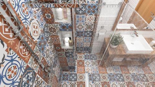 a bathroom with a sink and a tiled wall at Centric Baku Boutique Hotel in Baku
