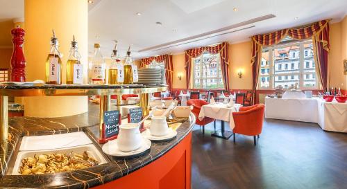 a restaurant with a counter with food on it at Dvorak Spa & Wellness in Karlovy Vary