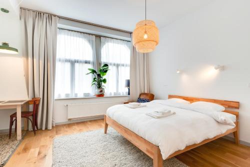 a bedroom with a bed and a desk and a window at Newton Boutique Hotel Residences - Brussels EU Area in Brussels