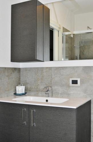 a kitchen with a sink and a mirror at La Casa di Armando in Bormio