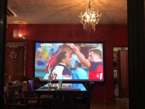 a television screen with a soccer game on it at HappyCloset&WasamonHostel in Kumamoto