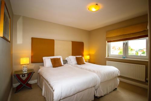 a bedroom with two beds and a window at Turnberry Apartments in Turnberry
