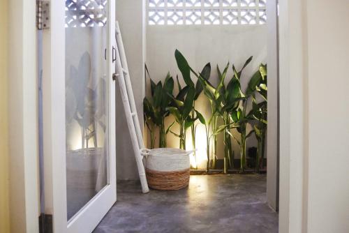 an open door leading into a room with plants at Amar Boutique Hotel in Canggu