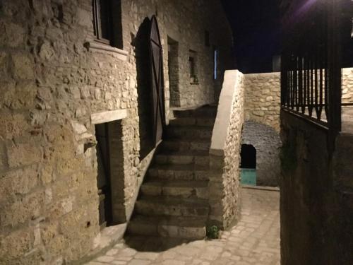 a stairway in an old stone building at night at La Portella in Oppido Lucano