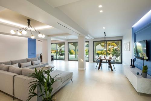 a living room with a couch and a table at Villa Onore in Dassia