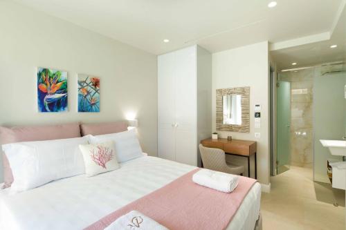 a bedroom with a bed and a bathroom with a sink at Villa Onore in Dassia