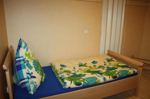 a bed with a blanket and a pillow on it at Monteur-/und Ferienwohnung Diehl in Aßlar