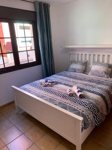 a bedroom with a bed with stuffed animals on it at Casa Achille in El Cotillo