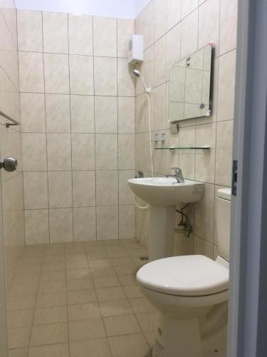 a bathroom with a toilet and a sink at 瑞恒行館Reui Heng Guesthouse in Budai