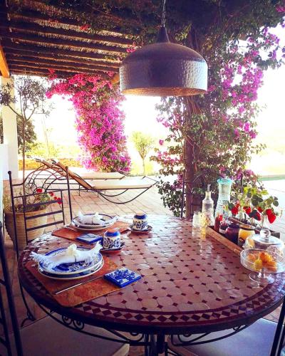 a table with plates of food on top at Sharish - Monte Das Estevas in Estremoz