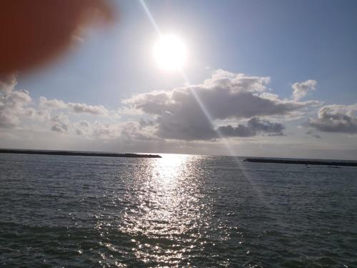 a view of the sun shining over the water at Taverna do Paraiso in Janga
