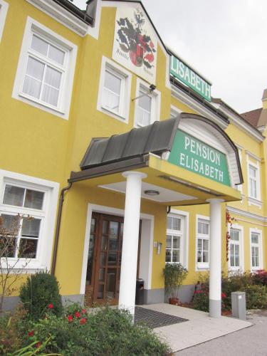 a yellow building with a sign in front of it at Pension Elisabeth in Sankt Pölten