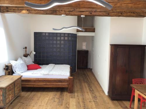 a living room with a bed and a table at Apartmány Sebastian in Mikulov