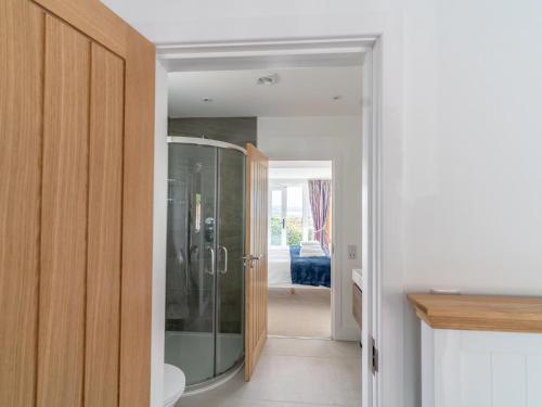 a bathroom with a glass shower in a room at Two Hoots in Kingsbridge