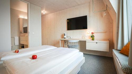 a hotel room with two beds and a sink at Hotel Bergamo in Ludwigsburg