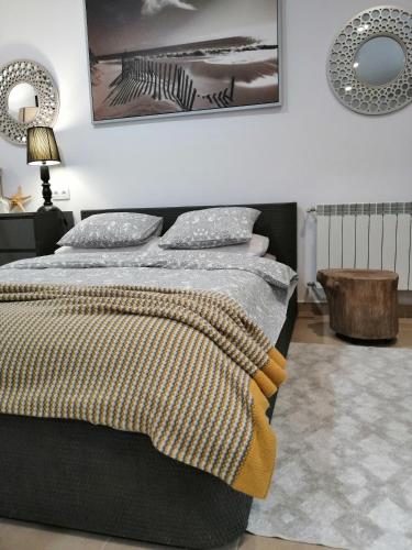 a bedroom with a bed with a blanket on it at Apartament Rondo in Trzebinia