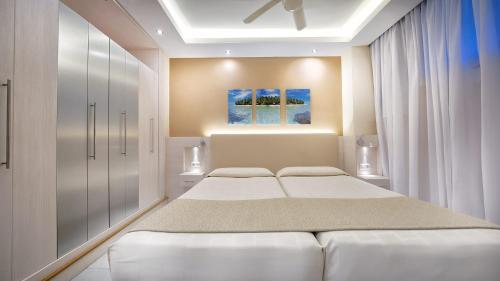 a bedroom with two beds and a painting on the wall at Bull Eugenia Victoria & Spa in Playa del Ingles