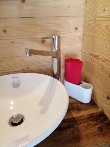 a bathroom with a white sink and a red towel at "forno one" - Bürchen Moosalp in Bürchen