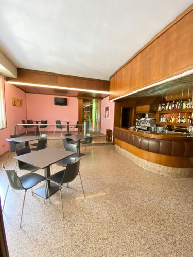 a restaurant with tables and chairs and a bar at Hotel Pamela in San Pietro in Casale