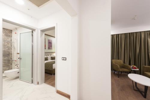 a room with a bathroom and a bedroom at ISG Sabiha Gökçen Airport Hotel in Istanbul