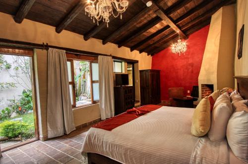 a bedroom with a large bed and a large window at Hotel San Marcos in San Cristóbal de Las Casas