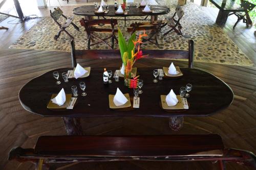 a black table with plates and napkins on it at Sublime Eco Hotel - Palomino Tayrona By GHO Hoteles in Palomino