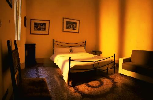 a bedroom with a bed and a couch at Palazzo Bargellini Panzacchi Apartments in Bologna