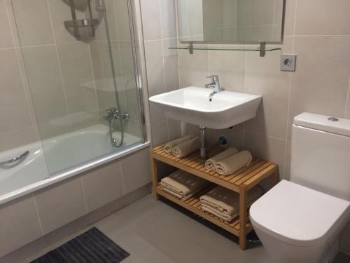 a bathroom with a sink and a toilet and a shower at TEJITA BEACH APARTMENT in El Médano