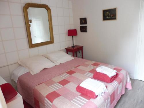 a bedroom with a bed with a mirror on it at La Lézardière in La Rochefoucauld