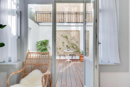 a glass door leading to a patio with a table at Newton Boutique Hotel Residences - Brussels EU Area in Brussels