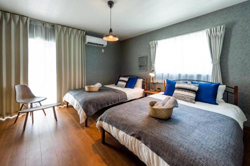 Cama o camas de una habitación en ペンション マカナレアビーチ沖縄