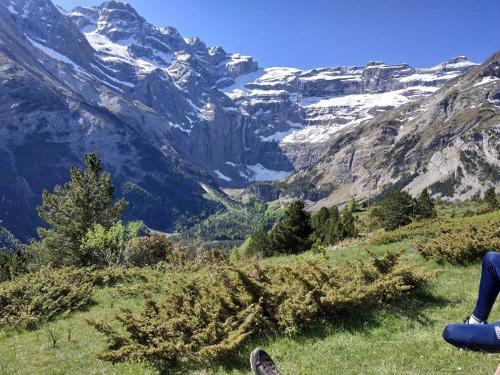 a person sitting on a hill looking at a mountain at BOYRIE Daniel et Hélène in Gavarnie