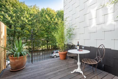 a patio with a table and chairs on a deck at Newton Boutique Hotel Residences - Brussels EU Area in Brussels