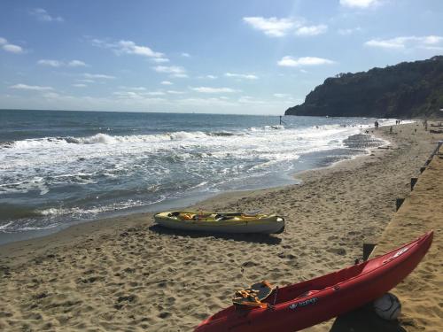a boat and a kayak on the beach at Little Gem with Private Hot Tub - Up to 25 percent off ferry in Shanklin