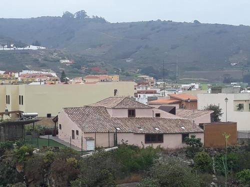 a group of buildings with a mountain in the background at Casa Doña Justa in Tegueste