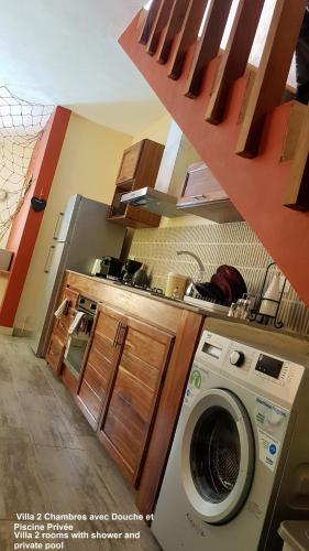 a kitchen with a washing machine in a room at Villa centre Grand Baie in Grand Baie