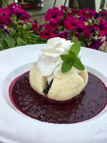 a dessert on a white plate with chocolate sauce at Apartmány Braníčkov in Branickov