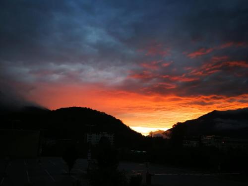 a sunset with the sun setting behind a mountain at Svarovsky in Bad Ischl
