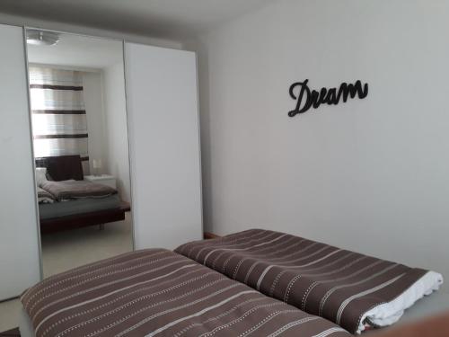 a bedroom with a couch and a mirror and a bed at Svarovsky in Bad Ischl