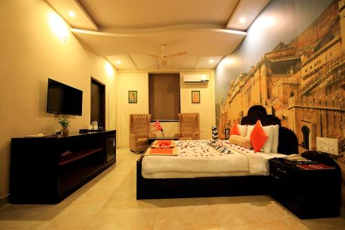 a bedroom with a large bed and a television at V One Pride in Jaipur