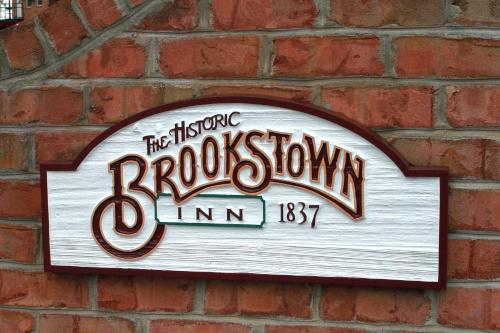 a sign on the side of a brick wall at The Historic Brookstown Inn, Trademark Collection by Wyndham in Winston-Salem
