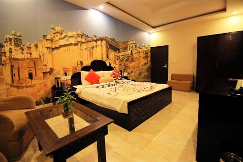 a room with a bed with a painting on the wall at V One Pride in Jaipur
