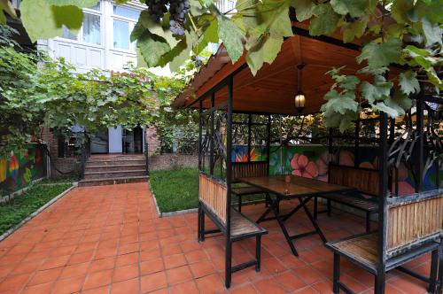 a patio with a table and chairs under a pavilion at Hotel Frida in Tbilisi City