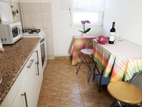 a small kitchen with a table and a microwave at Arena Apartment in Szombathely