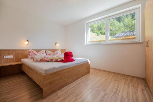 a bedroom with a bed with a window at Apartment Valentina in Neustift im Stubaital